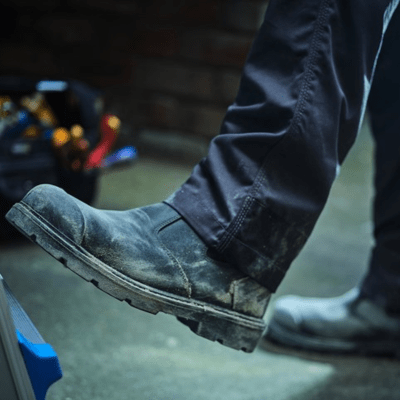 Tradesperson wearing slip on safety work boots