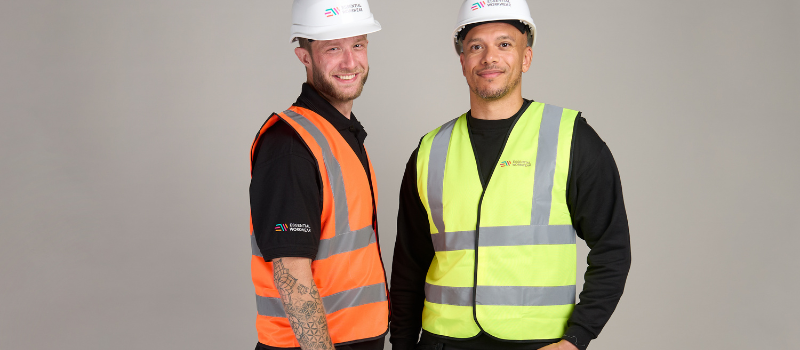 What to Know Before Branding Hi-Vis and PPE 2 Two men wearing branded hi-vis jackets, hardhats, and work trousers