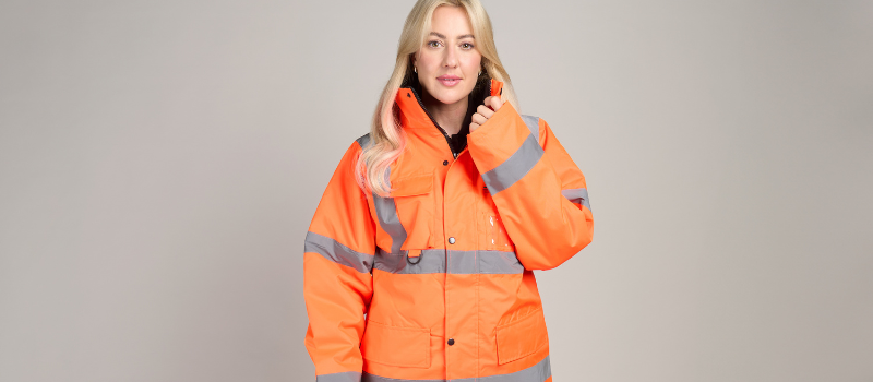 What to Know Before Branding Hi-Vis and PPE 3 Woman wearing orange waterproof hi-vis jacket with reflective strips