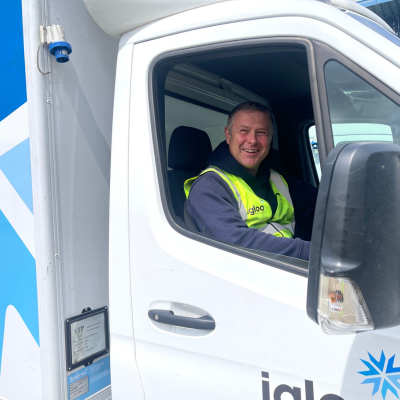 What to Know Before Branding Hi-Vis and PPE 3 Logistics van driver sat in his van smiling wearing a branded hi-vis vest