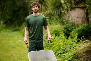 gardener working with a wheel burrow