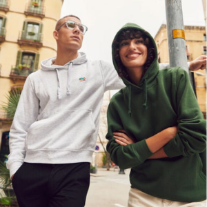 male and female wearing the Clique basic hoodie in grey and green