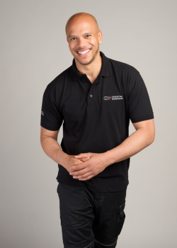 man wearing the essential workwear polo shirt in black